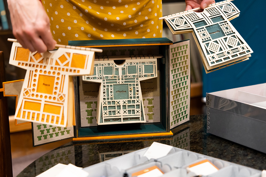 Closeup of an art book featuring three-dimensional paper dresses